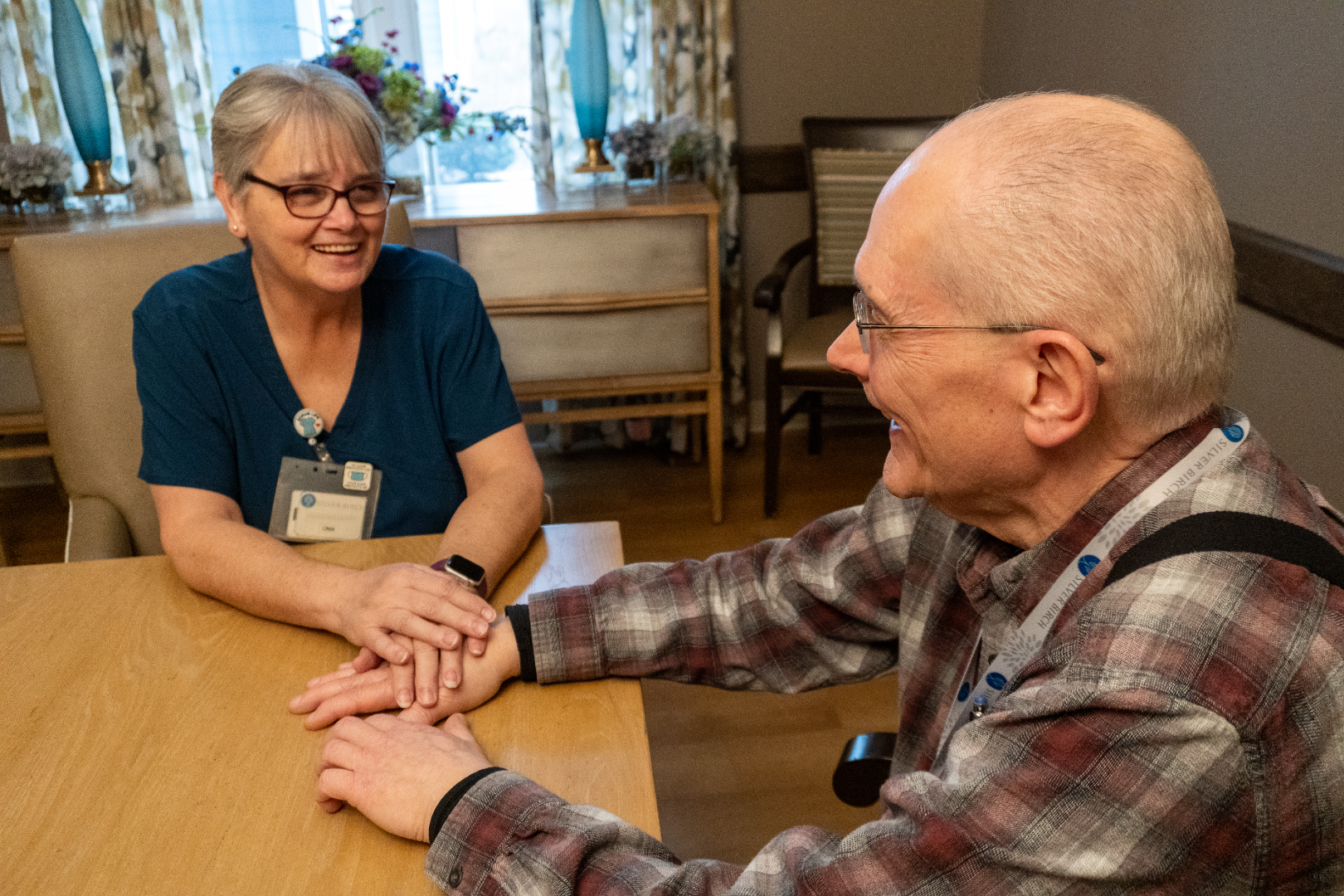 A nurse at Silver Birch of Mishawaka chatting with one  of her residents