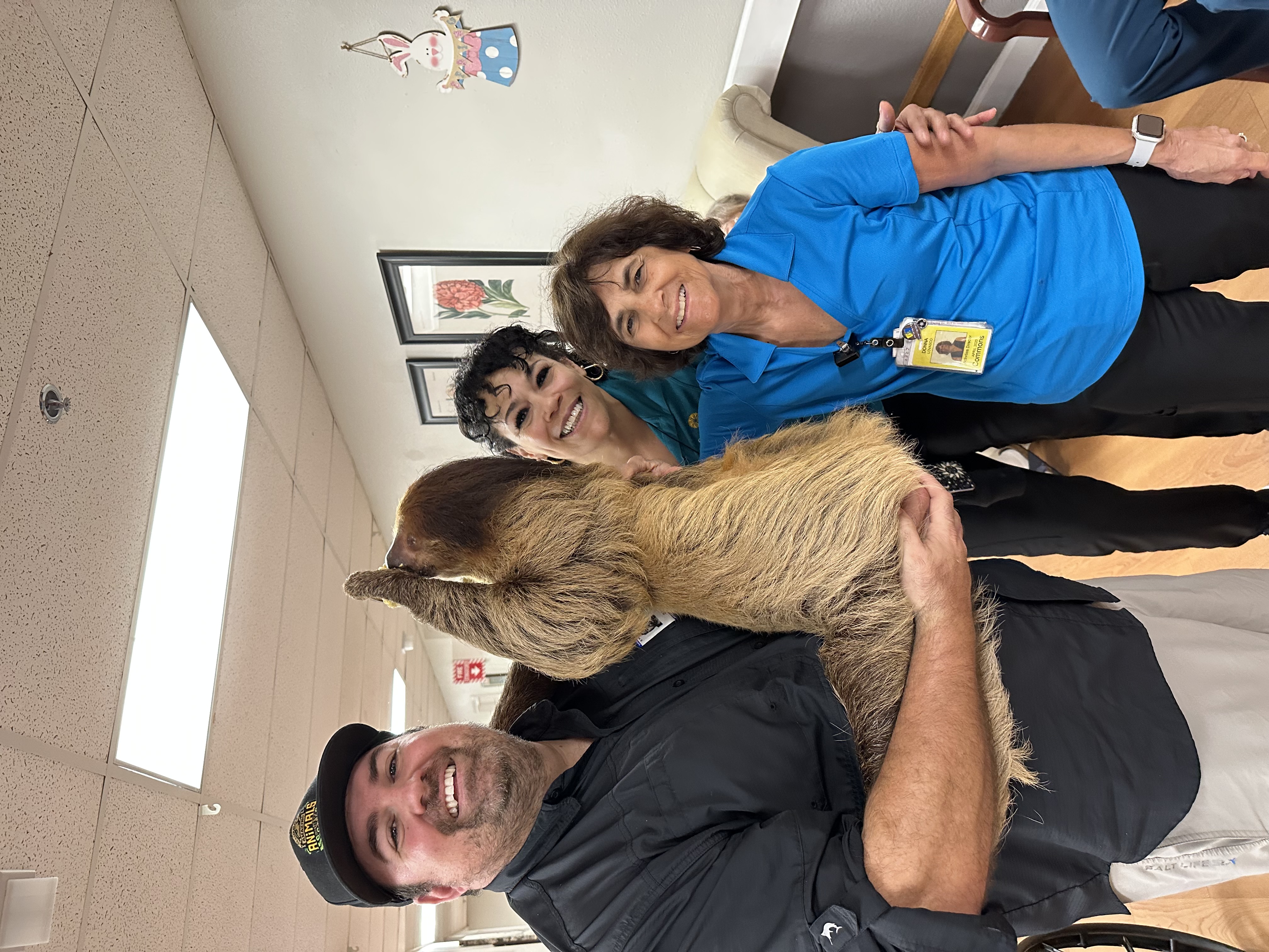 Team members enjoying a wild visit with exotic animals during an employee appreciation event.