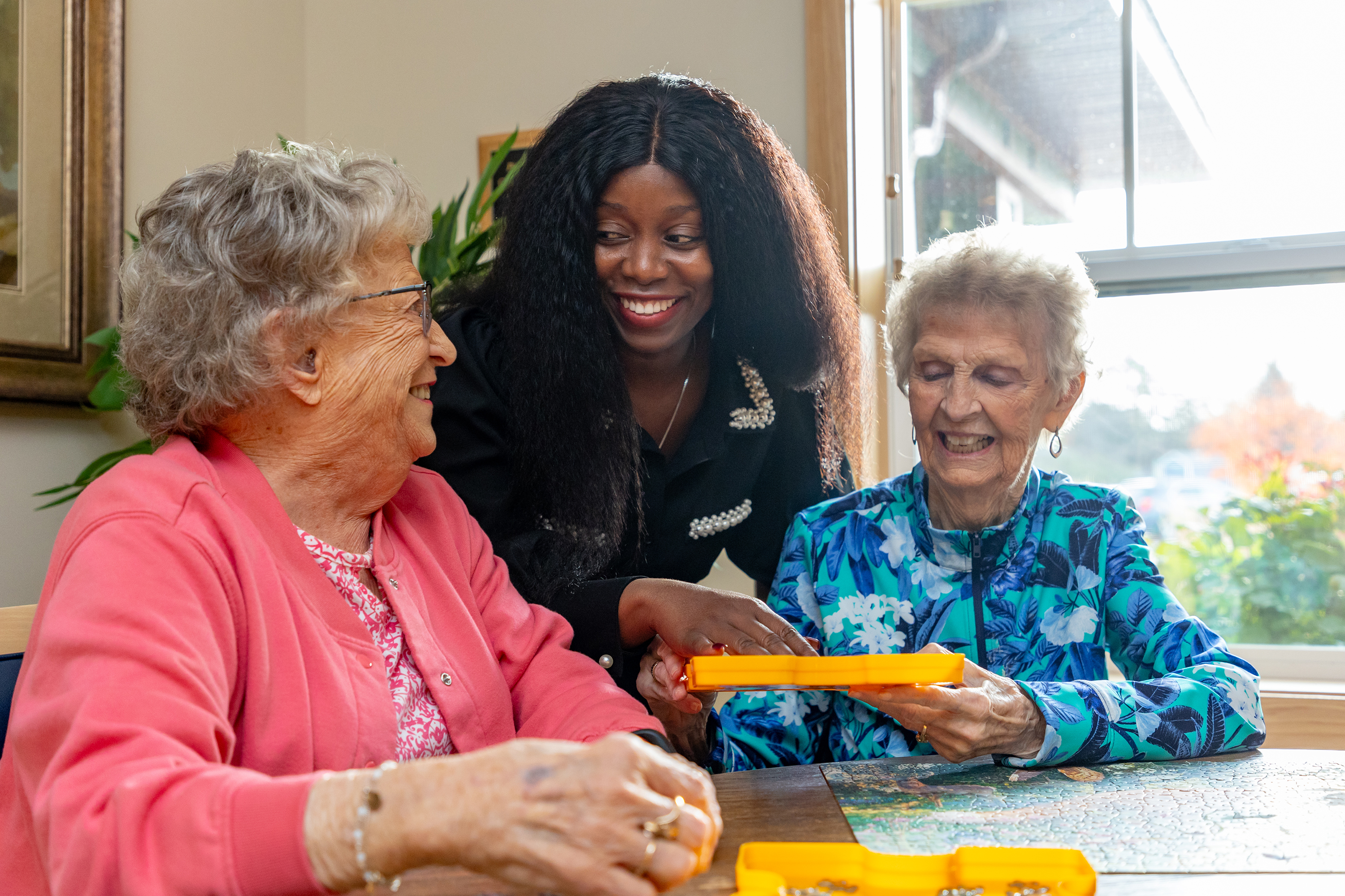 Residents and Staff from The Homestead at Anoka enjoying game night.
